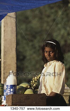 Girl standing at a market stall, Mathur, Tamil Nadu, India View Large Photo Image Stock Photo - Girl standing at a market stall, Mathur, Tamil Nadu, India. Fotosearch