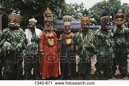 Group of Kummatti Kali dancers standing side by side, Kerala, India View Large Photo Image Stock Image - Group of Kummatti Kali dancers standing side by side, Kerala, India. Fotosearch
