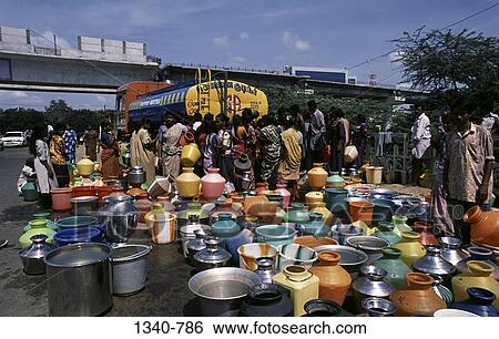 Group of people filling drinking water from a tanker, Chennai, Tamil Nadu, India View Large Photo Image Stock Photograph - Group of people filling drinking water from a tanker, Chennai, Tamil Nadu, India. Fotosearch