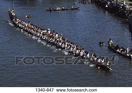 High angle view of a group of people participating in a traditional snake boat racing, Payippad Boat Race, Payippad Lake, Kerala, India View Large Photo Image Stock Photo - High angle view of a group of people participating in a traditional snake boat racing, Payippad Boat Race, Payippad Lake, Kerala, India. Fotosearch