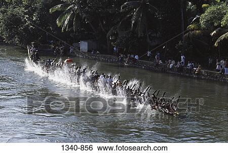 Stock Photograph - High angle view of a group of people participating in a traditional snake boat racing, Payippad Boat Race, Payippad Lake, Kerala, India. Fotosearch
