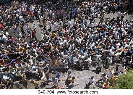 Picture - High angle view of devotees pulling a chariot in a religious chariot festival, Kapaleeshwarar Temple, Mylapore, Chennai, Tamil Nadu, India. Fotosearch