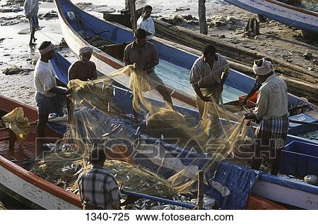 Stock Photography - High angle view of fishermen pulling a fishing net, Kanyakumari, Tamil Nadu, India. Fotosearch