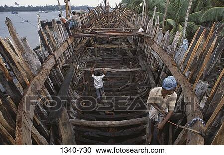 High angle view of workers making a wooden cargo boat, Cuddalore, Cuddalore District, Tamil Nadu, India View Large Photo Image Stock Image - High angle view of workers making a wooden cargo boat, Cuddalore, Cuddalore District, Tamil Nadu, India. Fotosearch