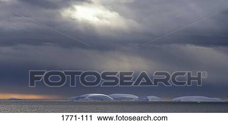 Stock Image - Icebergs floating in the sea, Paradise Bay, Antarctic Peninsula, Antarctica. Fotosearch
