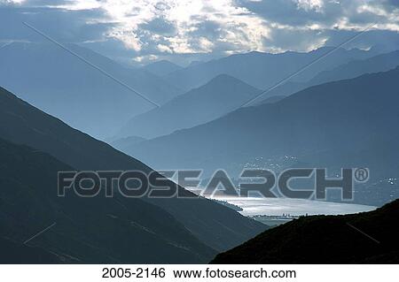 Lake surrounded by mountains, Lake Wakatipu, Queenstown, New Zealand View Large Photo Image Stock Photograph - Lake surrounded by mountains, Lake Wakatipu, Queenstown, New Zealand. Fotosearch