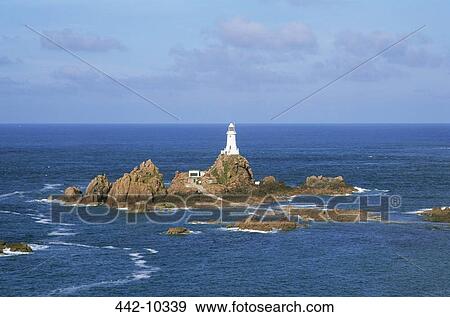 Stock Photo - Lighthouse in the sea, La Corbiere Lighthouse, Jersey, Channel Islands. Fotosearch