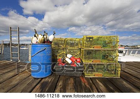 Lobster traps and lobster buoys on a fishing pier, Rocky Neck, Gloucester, Cape Ann, Massachusetts, USA View Large Photo Image Stock Photo - Lobster traps and lobster buoys on a fishing pier, Rocky Neck, Gloucester, Cape Ann, Massachusetts, USA. Fotosearch
