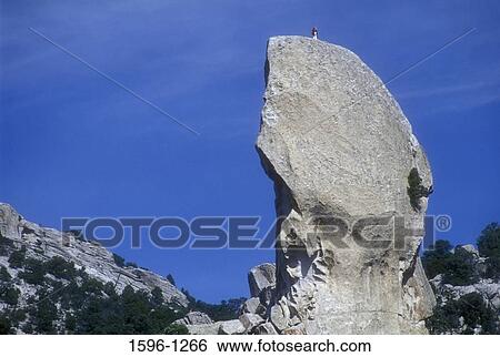 Low angle view of a person standing on the top of a rock, Pillar Rock, City Of Rocks, Idaho, USA View Large Photo Image Stock Photograph - Low angle view of a person standing on the top of a rock, Pillar Rock, City Of Rocks, Idaho, USA. Fotosearch