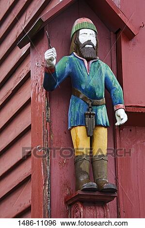 Low angle view of a statue of a lumberjack on a building, Historic Bryggen District, Bergen, Norway View Large Photo Image Stock Photograph - Low angle view of a statue of a lumberjack on a building, Historic Bryggen District, Bergen, Norway. Fotosearch