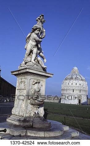 Low angle view of a statue with a building in the background, Baptistry, Pisa, Tuscany, Italy View Large Photo Image Picture - Low angle view of a statue with a building in the background, Baptistry, Pisa, Tuscany, Italy. Fotosearch