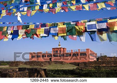 Low angle view of prayer flags with a temple in the background, Maya Devi Temple, Lumbini, Nepal View Large Photo Image Stock Photography - Low angle view of prayer flags with a temple in the background, Maya Devi Temple, Lumbini, Nepal. Fotosearch