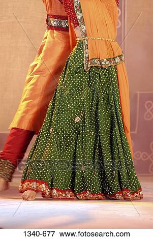 Stock Photo - Low section view of a man and a woman performing Kathaka, classical dance of India, India. Fotosearch