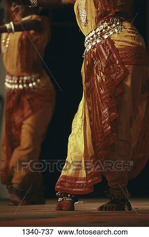 Low section view of two women performing Odissi the Indian classical dance, India View Large Photo Image Stock Photo - Low section view of two women performing Odissi the Indian classical dance, India. Fotosearch