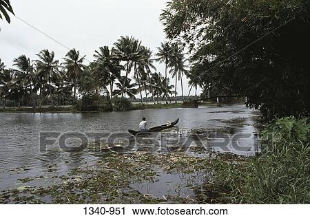 Man in a boat, Kuttanad, Alappuzha District, Kerala, India View Large Photo Image Stock Image - Man in a boat, Kuttanad, Alappuzha District, Kerala, India. Fotosearch