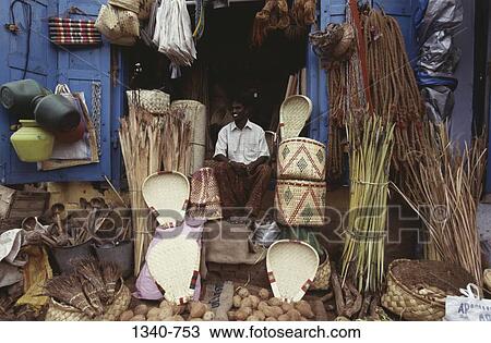 Stock Image - Man selling palm leaf products, Tamil Nadu, India. Fotosearch