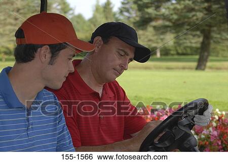 Mature man and his son updating scorecard in a golf cart View Large Photo Image Stock Photograph - Mature man and his son updating scorecard in a golf cart. Fotosearch