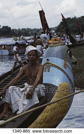 Stock Photography - Mature man sitting on a Thiruvonam Thoni a special boat built two centuries ago for temple use, Aranmula Boat Race, Aranmula, Kerala, India. Fotosearch