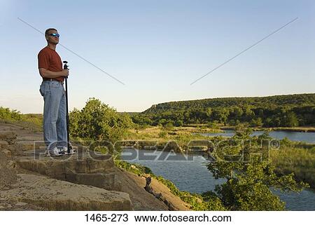 Mature man standing on a cliff at the riverside, Brazos River, Texas, USA View Large Photo Image Stock Image - Mature man standing on a cliff at the riverside, Brazos River, Texas, USA. Fotosearch