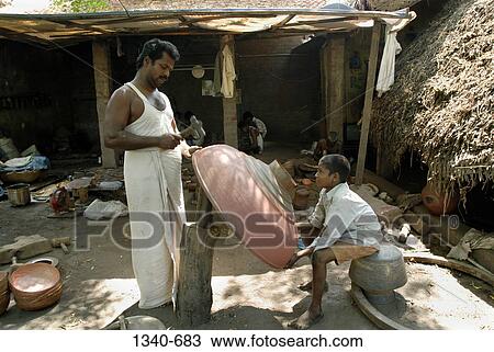 Mid adult man and his son making a gopura kalasam, Darasuram, Thanjavur District, Tamil Nadu, India View Large Photo Image Stock Image - Mid adult man and his son making a gopura kalasam, Darasuram, Thanjavur District, Tamil Nadu, India. Fotosearch