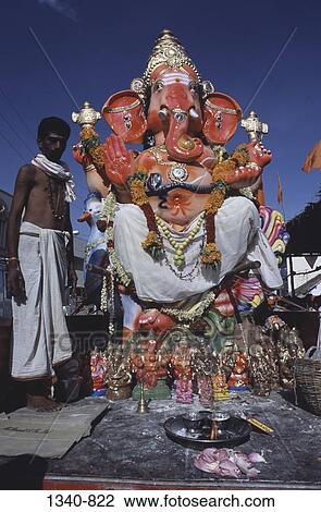 Mid adult man standing near a statue of Lord Ganesha, Tamil Nadu, India View Large Photo Image Stock Image - Mid adult man standing near a statue of Lord Ganesha, Tamil Nadu, India. Fotosearch