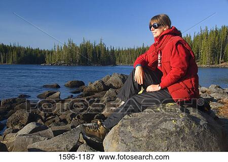 Mid adult woman sitting on a rock, Waldo Lake, Waldo Lake Scenic Waterway, Willamette National Forest, Oregon, USA View Large Photo Image Stock Photo - Mid adult woman sitting on a rock, Waldo Lake, Waldo Lake Scenic Waterway, Willamette National Forest, Oregon, USA. Fotosearch