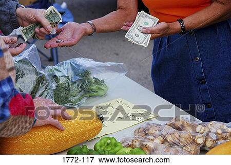 Mid section view of a woman collecting payment for a purchase at a farmer's market, Wyoming, USA View Large Photo Image Stock Photo - Mid section view of a woman collecting payment for a purchase at a farmer's market, Wyoming, USA. Fotosearch