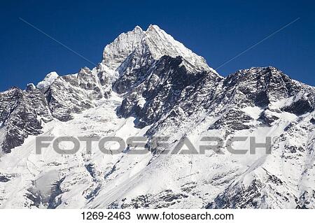 Mountain covered with snow, Thamserku, Sagarmatha National Park, Khumbu, Nepal View Large Photo Image Stock Image - Mountain covered with snow, Thamserku, Sagarmatha National Park, Khumbu, Nepal. Fotosearch
