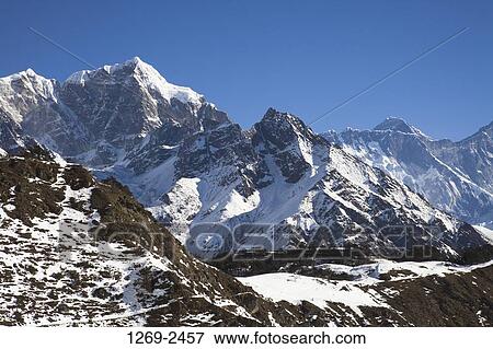 Stock Photo - Mountains covered with snow, Sagarmatha National Park, Nepal. Fotosearch