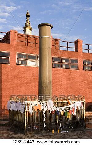 Prayer flag around a column at a temple, Ashoka Pillar, Maya Devi Temple, Lumbini, Nepal View Large Photo Image Stock Photo - Prayer flag around a column at a temple, Ashoka Pillar, Maya Devi Temple, Lumbini, Nepal. Fotosearch