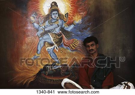 Priest sitting in front of a painting of Lord Shiva in a temple, Kerala, India View Large Photo Image Stock Image - Priest sitting in front of a painting of Lord Shiva in a temple, Kerala, India. Fotosearch