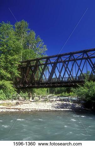 Stock Image - Railway bridge across a river, Olympic Discovery Trail, Railroad Bridge Park, Sequim, Clallam County, Washington State, USA. Fotosearch