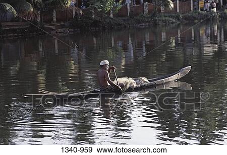 Rear view of a fisherman rowing a boat in a lake, Kerala Backwaters, Kuttanad, Alappuzha District, Kerala, India View Large Photo Image Stock Photo - Rear view of a fisherman rowing a boat in a lake, Kerala Backwaters, Kuttanad, Alappuzha District, Kerala, India. Fotosearch