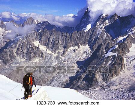 Rear view of two people hiking on a mountain, Grandes Jorasses, Vallee Blanc, Mont Blanc Massif, Chamonix, France View Large Photo Image Stock Image - Rear view of two people hiking on a mountain, Grandes Jorasses, Vallee Blanc, Mont Blanc Massif, Chamonix, France. Fotosearch