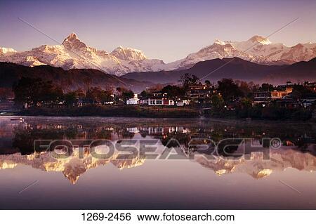 Reflection of mountains in a lake, Fewa Lake, Pokhara, Nepal View Large Photo Image Stock Photograph - Reflection of mountains in a lake, Fewa Lake, Pokhara, Nepal. Fotosearch