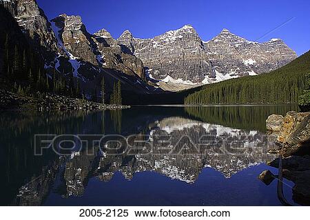 Stock Photography - Reflection of mountains in water, Valley Of The Ten Peaks, Moraine Lake, Banff National Park, Alberta, Canada. Fotosearch