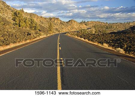 Road passing along mountains, Lava Beds National Monument, California, USA View Large Photo Image Stock Image - Road passing along mountains, Lava Beds National Monument, California, USA. Fotosearch