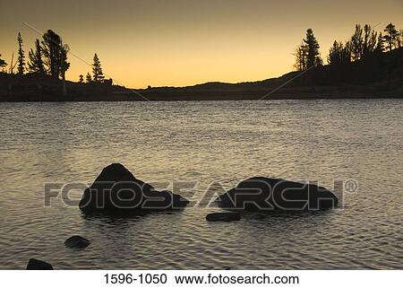 Stock Image - Rock formations in a lake, Frog Lake, Mokelumne Wilderness, Carson Pass Scenic Byway, California, USA. Fotosearch