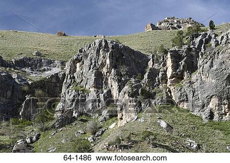 Stock Photograph - Rock formations on a landscape, Wind River Canyon, Wyoming, USA. Fotosearch