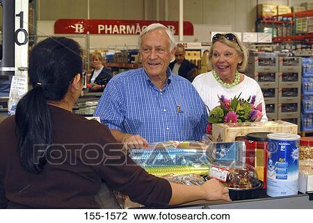 Senior man and a mature woman shopping in a store View Large Photo Image Stock Image - Senior man and a mature woman shopping in a store. Fotosearch