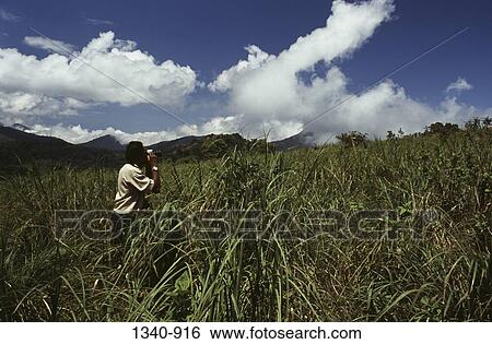 Side profile of a man taking a picture in a field, Silent Valley National Park, Palakkad District, Kerala, India View Large Photo Image Stock Photograph - Side profile of a man taking a picture in a field, Silent Valley National Park, Palakkad District, Kerala, India. Fotosearch