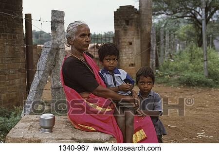 Side profile of a mature woman with her two grandsons, Tamil Nadu, India View Large Photo Image Stock Photo - Side profile of a mature woman with her two grandsons, Tamil Nadu, India. Fotosearch