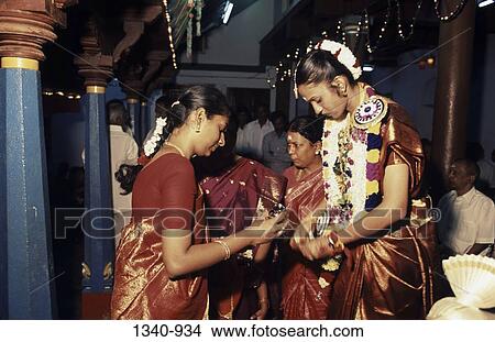 Side profile of a mid adult woman preparing bride in a wedding ceremony, Chettinad, Tamil Nadu, India View Large Photo Image Picture - Side profile of a mid adult woman preparing bride in a wedding ceremony, Chettinad, Tamil Nadu, India. Fotosearch