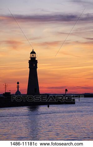 Stock Image - Silhouette of a lighthouse at dusk, Buffalo Lighthouse, Buffalo Port, New York State, USA. Fotosearch
