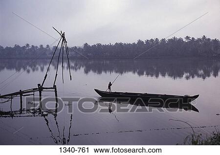 Silhouette of a man in a boat near a Chinese fishing net, Kodungallur, Cochin, Kerala, India View Large Photo Image Stock Image - Silhouette of a man in a boat near a Chinese fishing net, Kodungallur, Cochin, Kerala, India. Fotosearch
