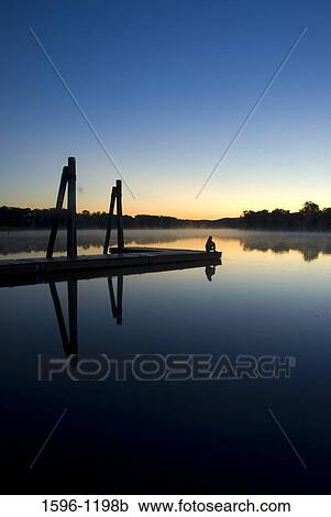 Silhouette of a person sitting on a pier at dawn, Connecticut River, Ferry Park, Rocky Hill, Connecticut, USA View Large Photo Image Stock Image - Silhouette of a person sitting on a pier at dawn, Connecticut River, Ferry Park, Rocky Hill, Connecticut, USA. Fotosearch