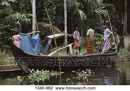 Three men and a woman standing in a boat, Kerala, India View Large Photo Image Stock Image - Three men and a woman standing in a boat, Kerala, India. Fotosearch