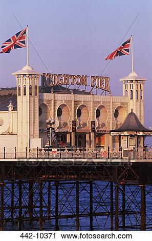 Stock Image - Tourist resort on a pier, Palace Pier, Brighton, Sussex, England. Fotosearch