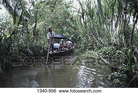 Stock Photograph - Tourists in a boat, Kuttanad, Alappuzha District, Kerala, India. Fotosearch