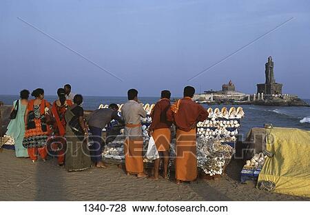 Tourists on the beach with a statue and a memorial in the background, Vivekananda Rock Memorial, Kanyakumari, Kanyakumari District, Tamil Nadu, India View Large Photo Image Stock Photo - Tourists on the beach with a statue and a memorial in the background, Vivekananda Rock Memorial, Kanyakumari, Kanyakumari District, Tamil Nadu, India. Fotosearch